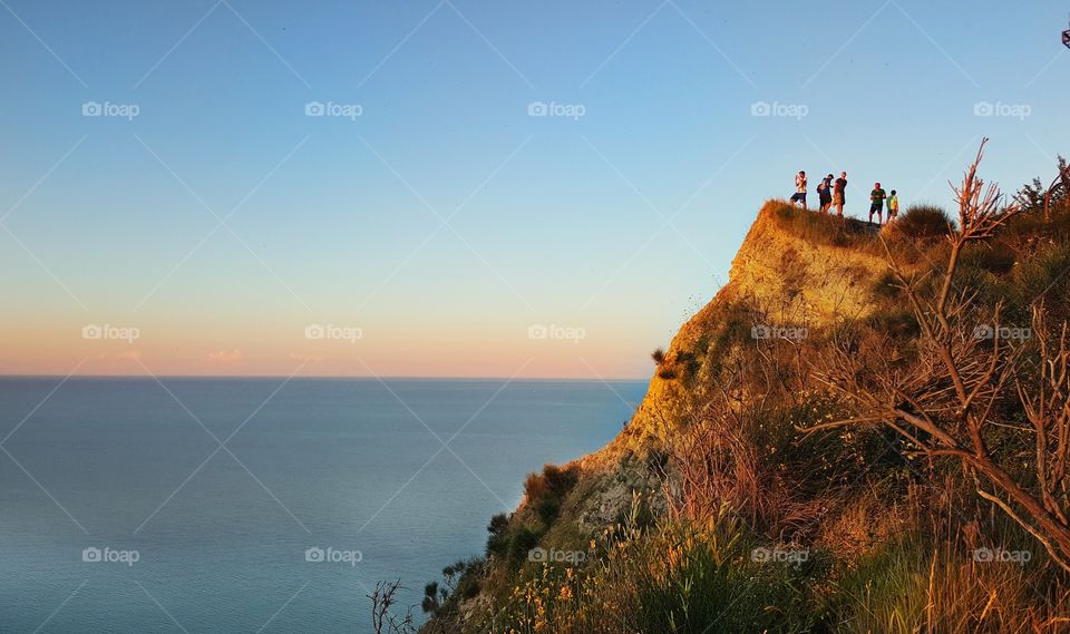 people on a cliff in pesaro, Italy