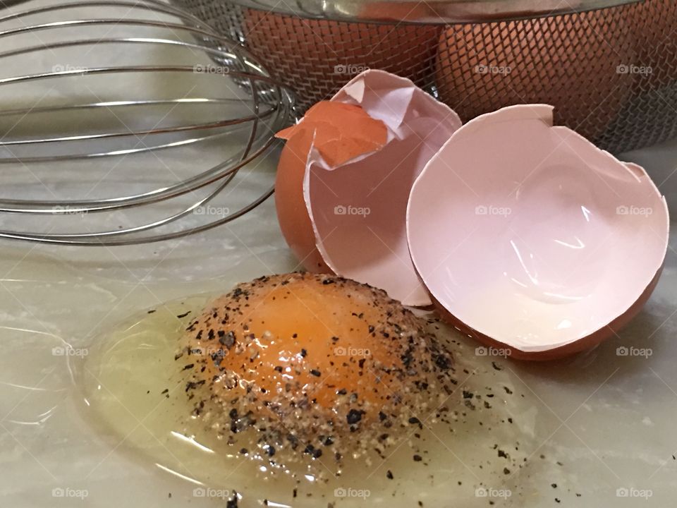 Seasoned farm fresh raw brown egg and its shell closeup 