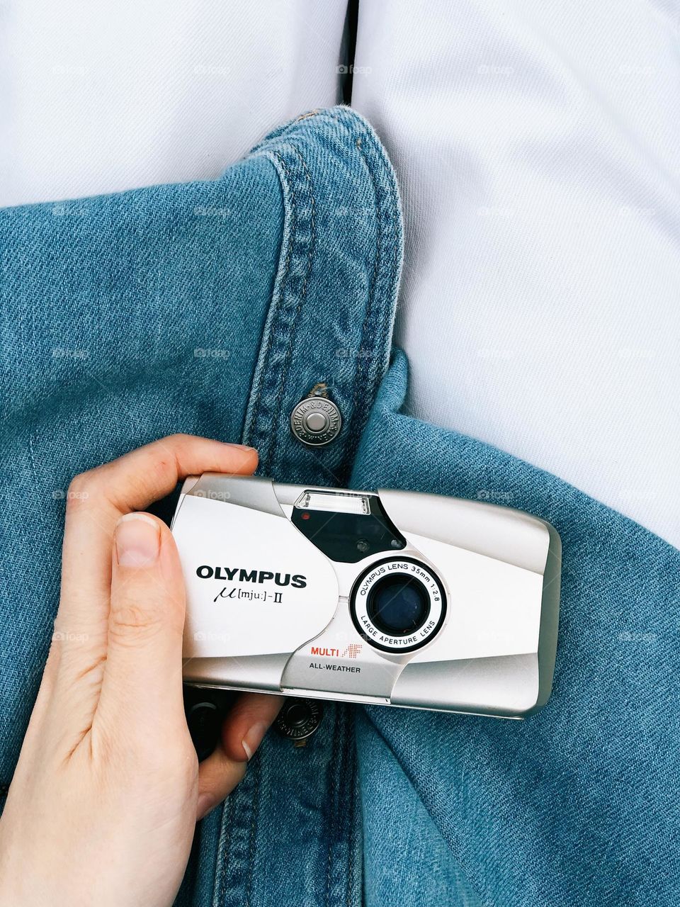 Close-up of a woman's hand holding a film camera