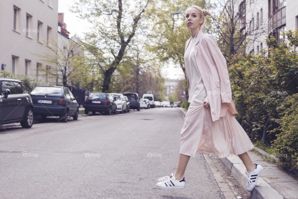 Woman walking on sidewalk