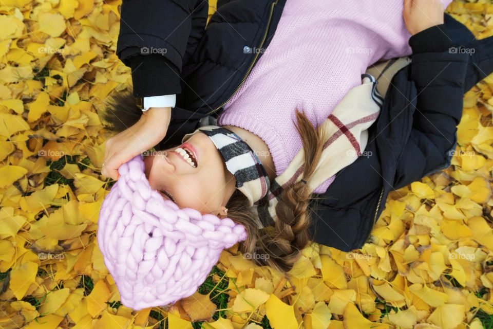 Happy woman on yellow leaves 