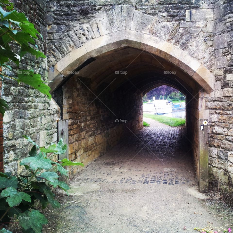 Old stone archway under bridge