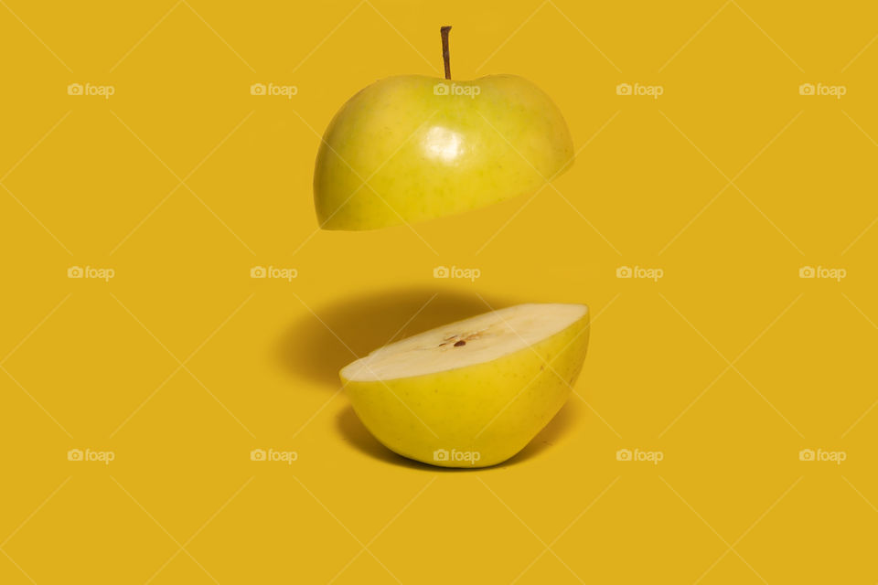 Apple sliced on half with one floating half.Creative food concept