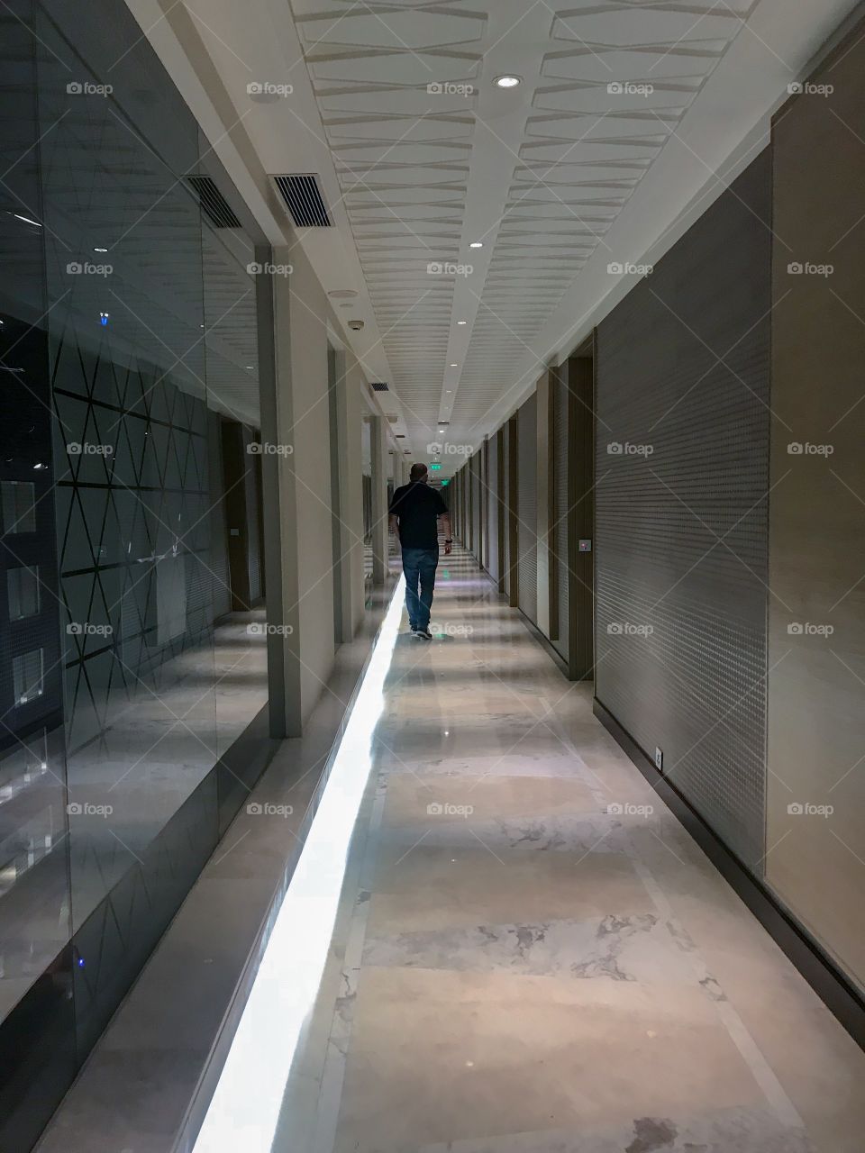 Walk along the lit corridors of the hotel ...with light, mirrors & length...