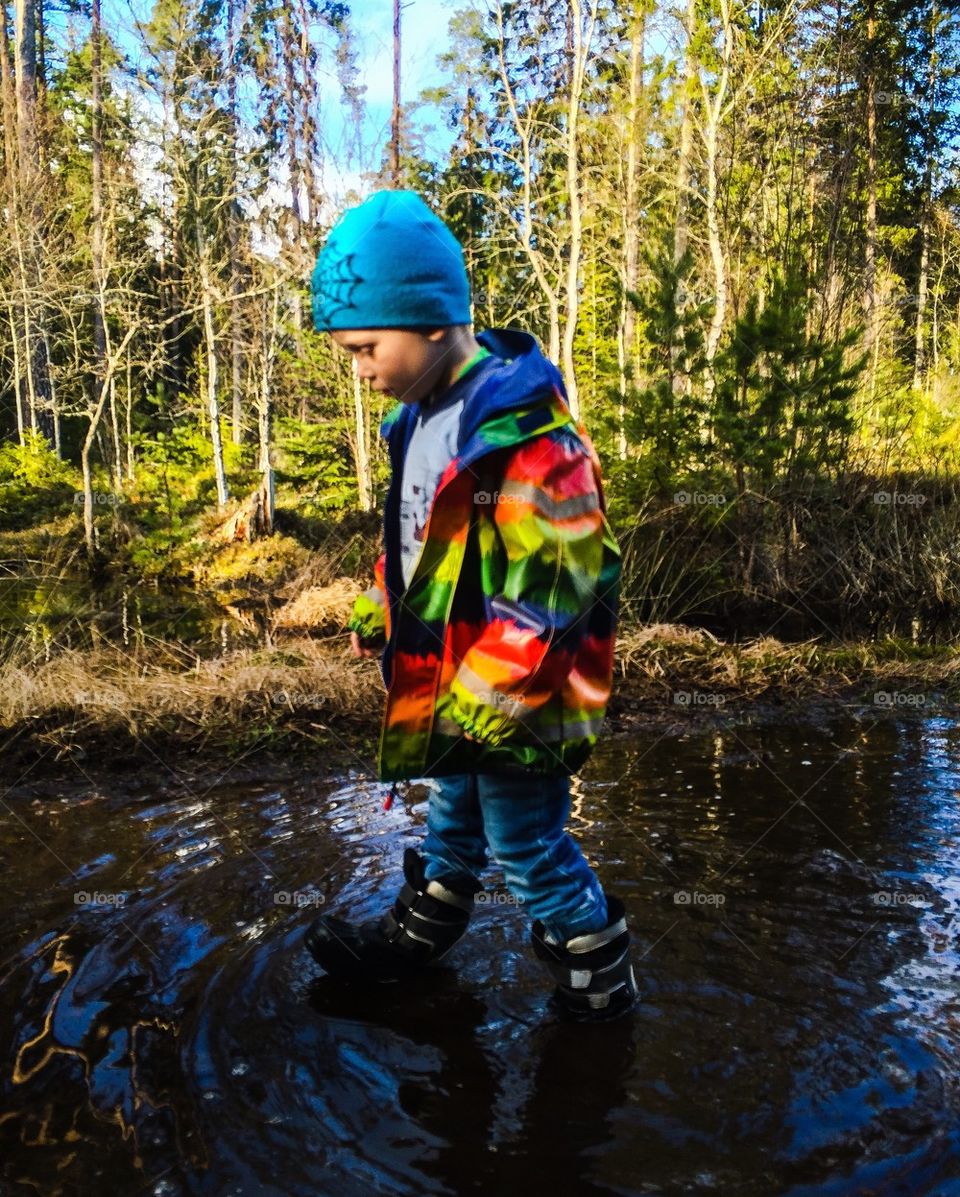 Boy walking in water