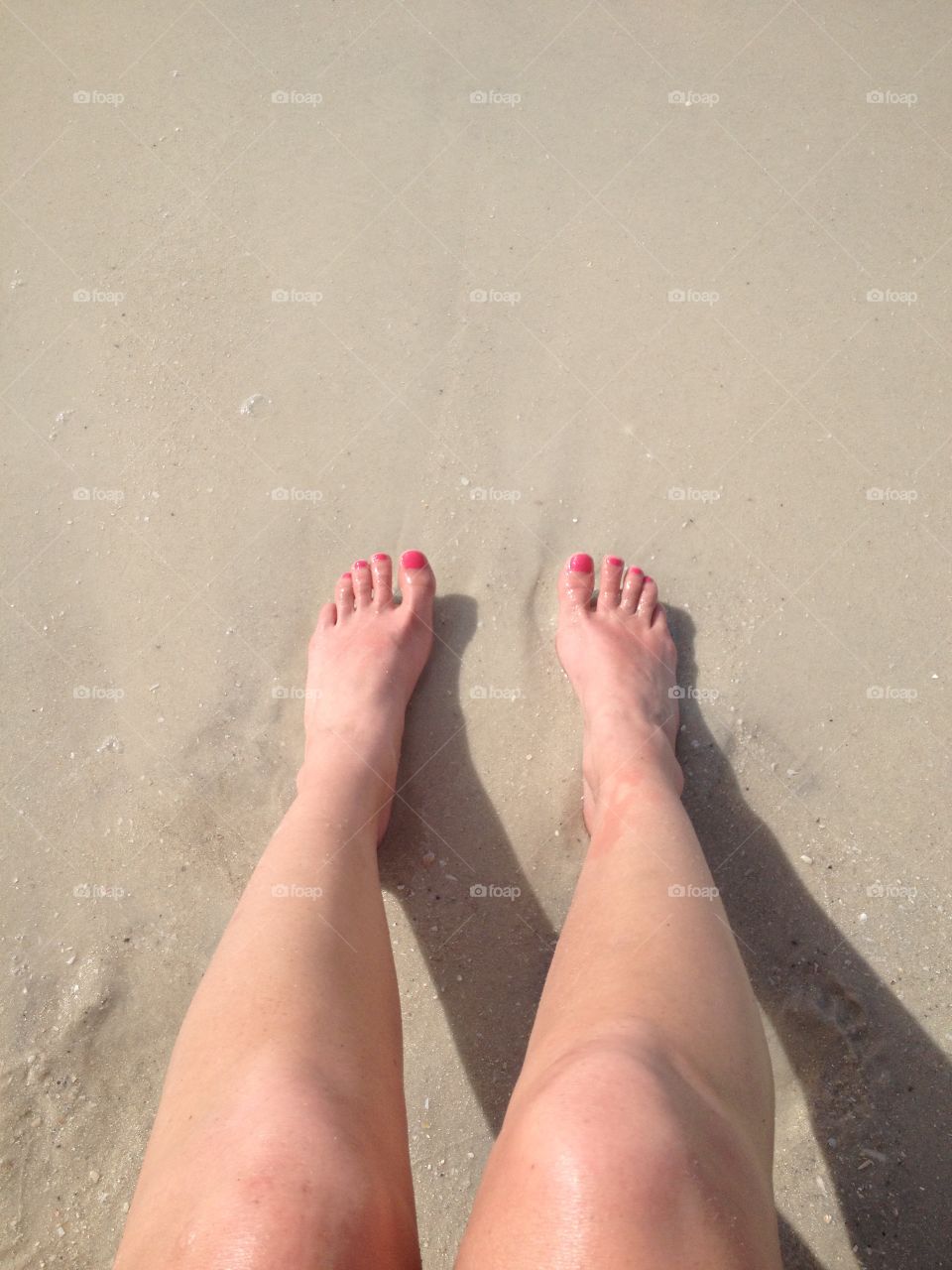 Feet in the sand in Naples, FL.
