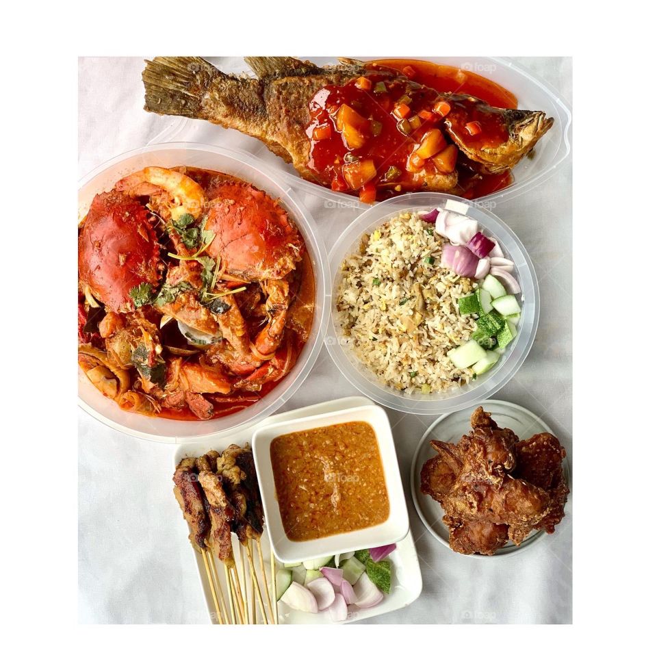 Halal feast consisting of chilli crab shellout, chicken satay fried rice, chicken satay sticks, sweet sour seabass and chicken wings