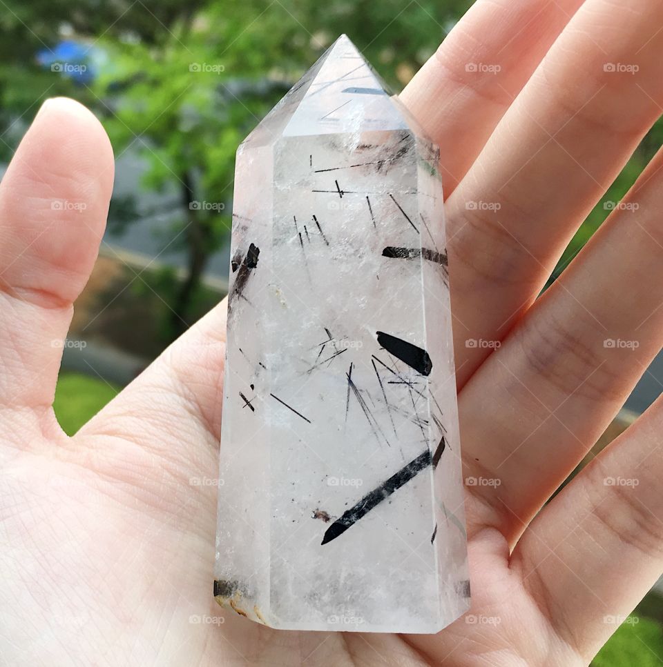 A black tourmaline and clear quartz crystal tower point.
