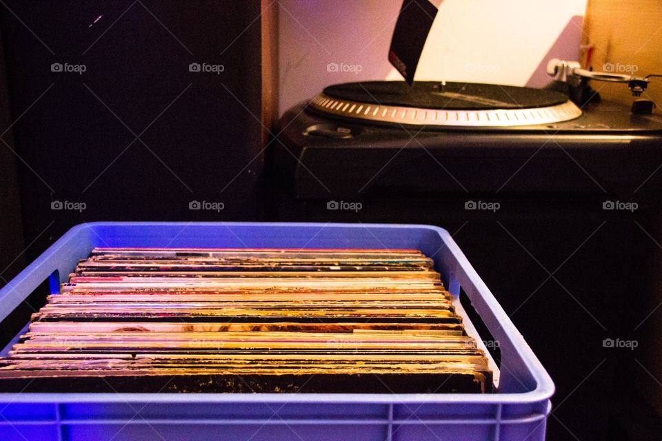 Photo of a turntable and a crate of records