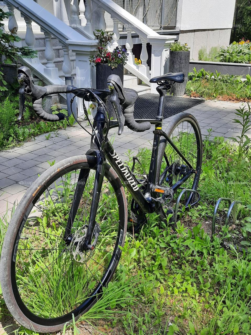 one lonely bicycle in front of a house