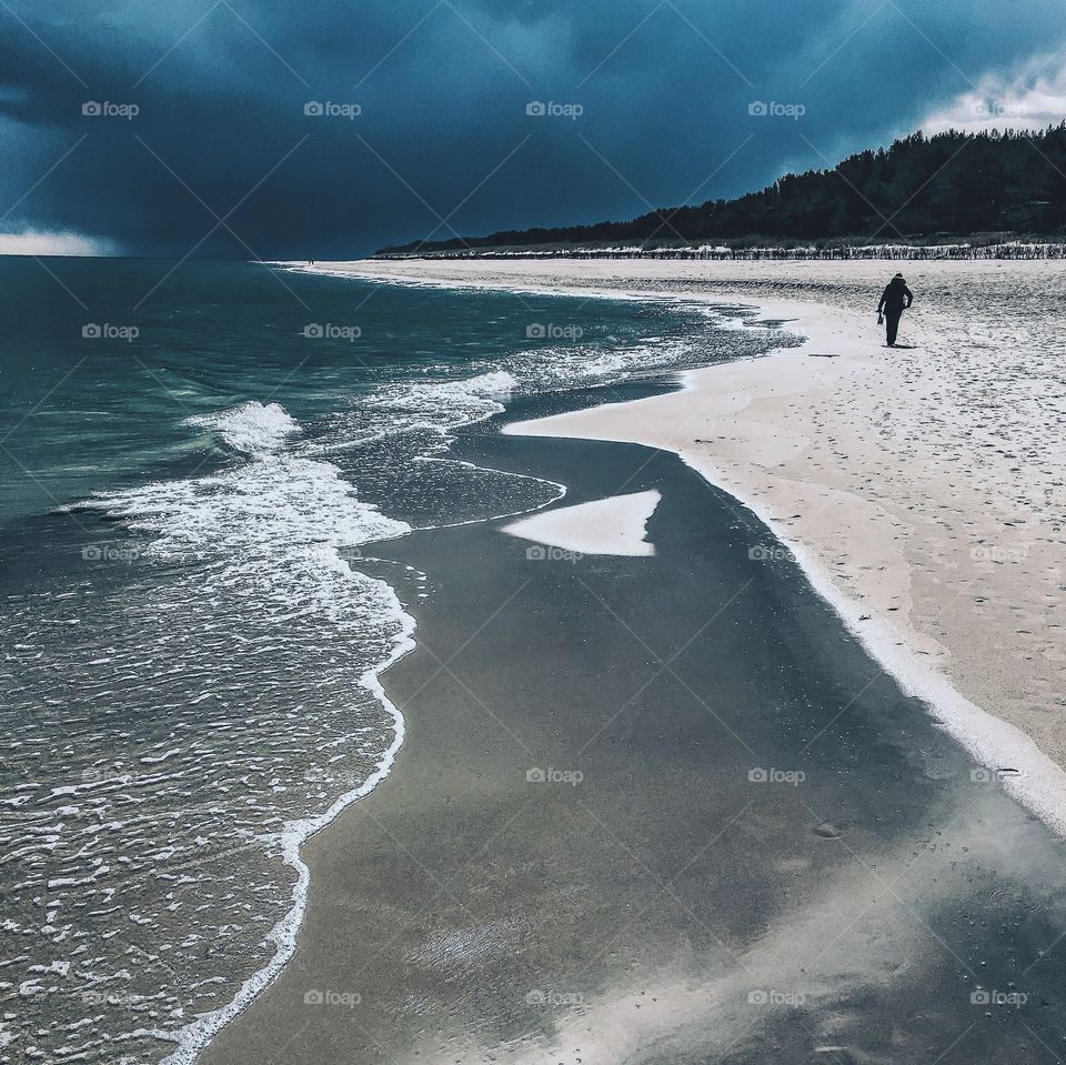 A person on cloudy beach