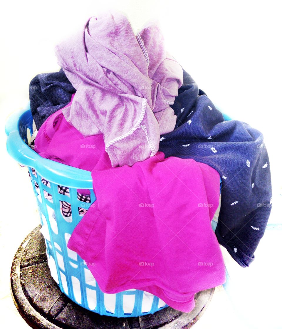 The clothes in the used basket are waiting to be washed.