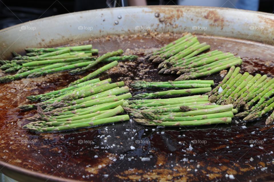 Delicious asparagus in a big outdoor frying pan