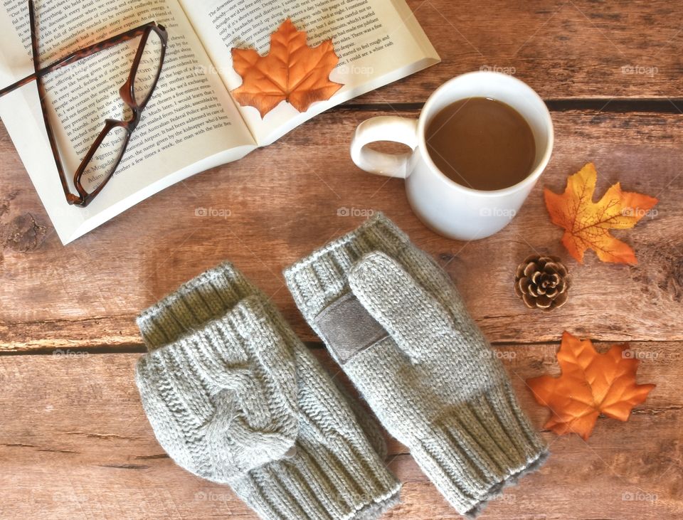 Autumn coffee, gloves, book and glasses flat lay still life 