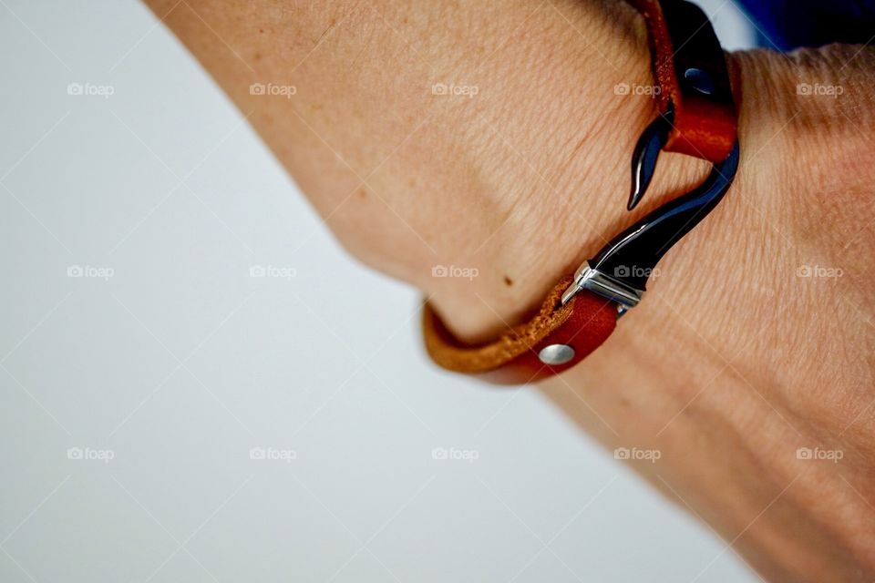 Model Wearing Handmade Leather Bracelet With Metal Hook Clasp, Closeup Still Life Photography 