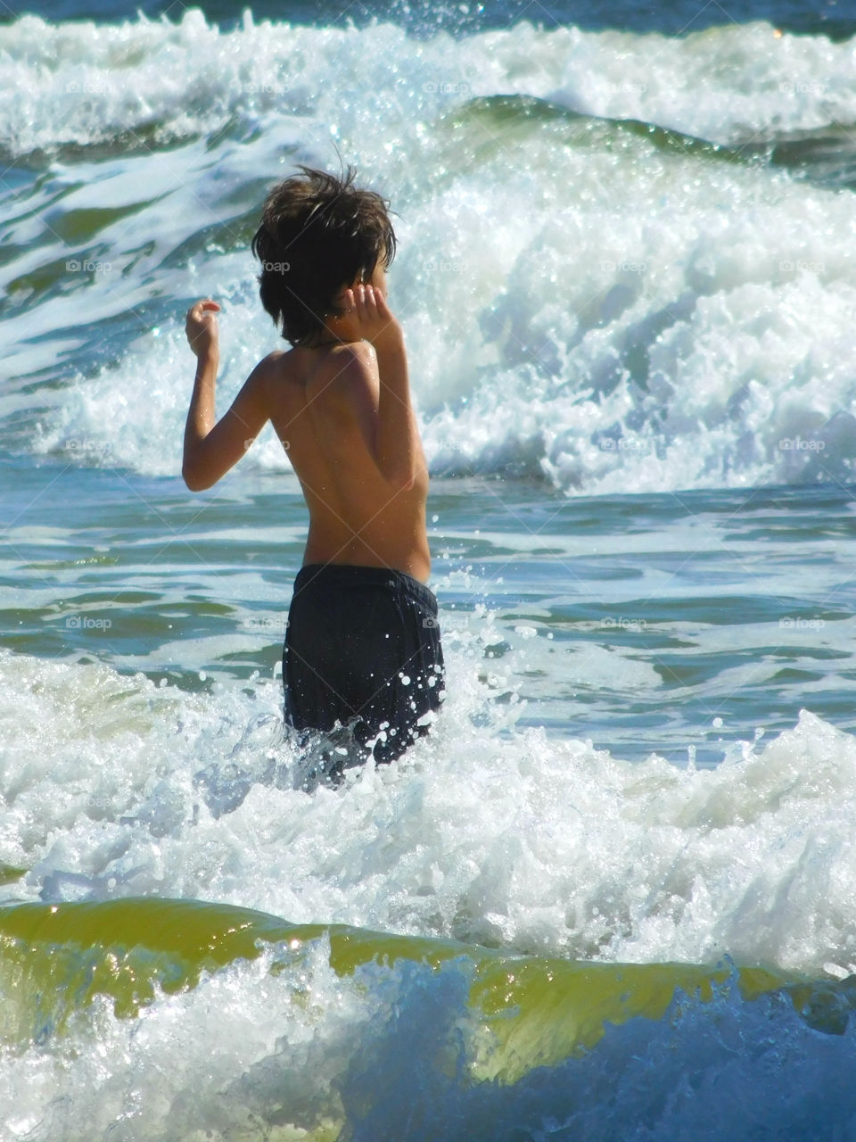 "Oh Mommy"! The water is chilly!
This young boy was on Spring vacation with his family and could not wait to test the Gulf of Mexico ocean waters! Although chilly, he managed to stay in the water for several minutes! Spring fling!