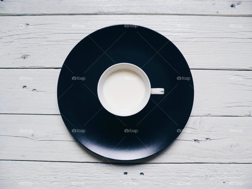 a cup of milk on a black background