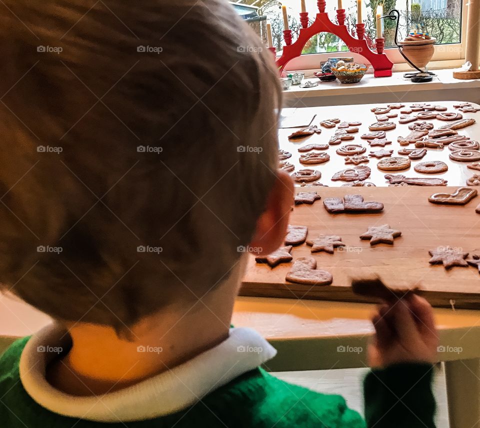 Kid looking at the gingerbread he made