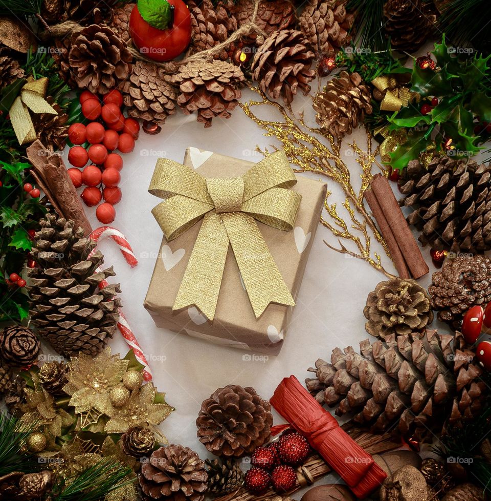 Festive flat lay of decorations centred around a wrapped present
