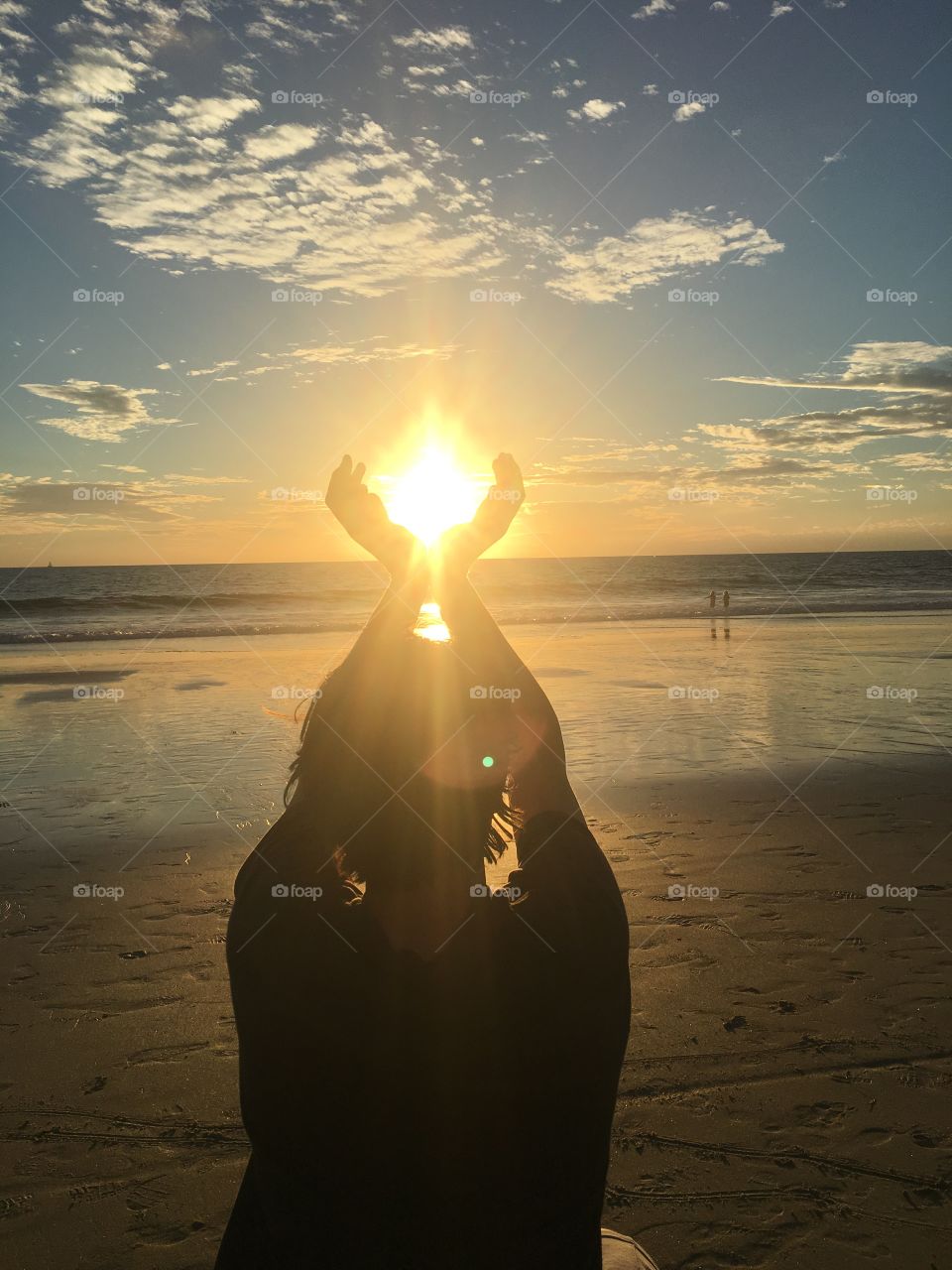 Holding sun with hands