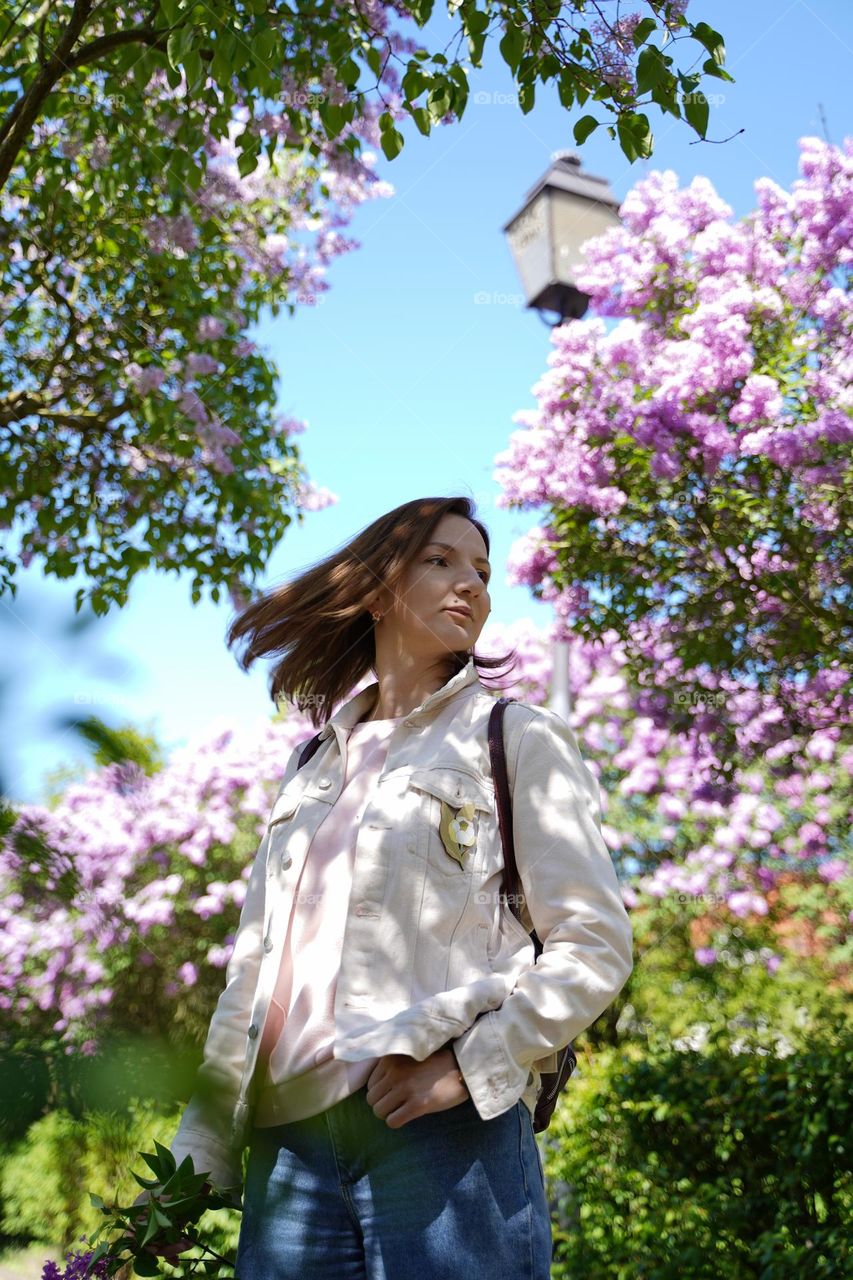 Girl in lilac flowers