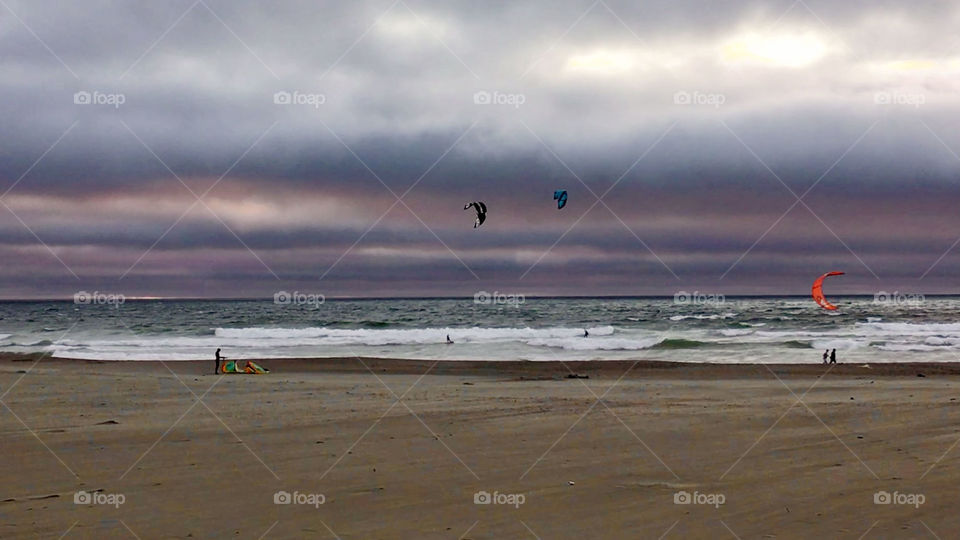 Kite surfers and sunset at Ocean beach, California 