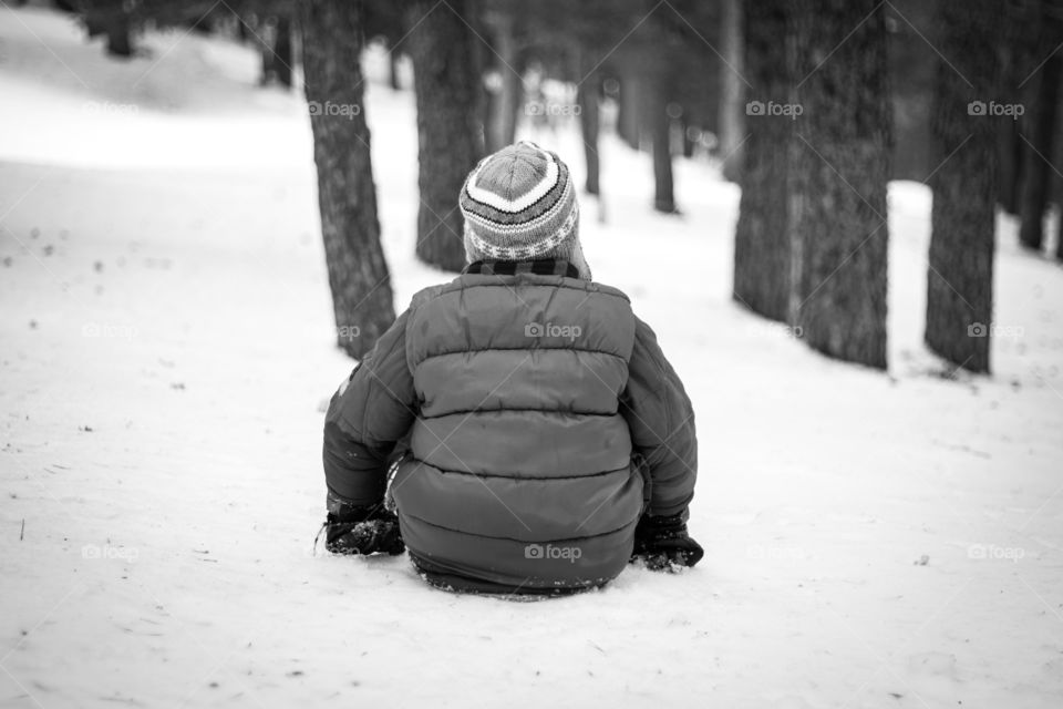 Child sitting in the snow
