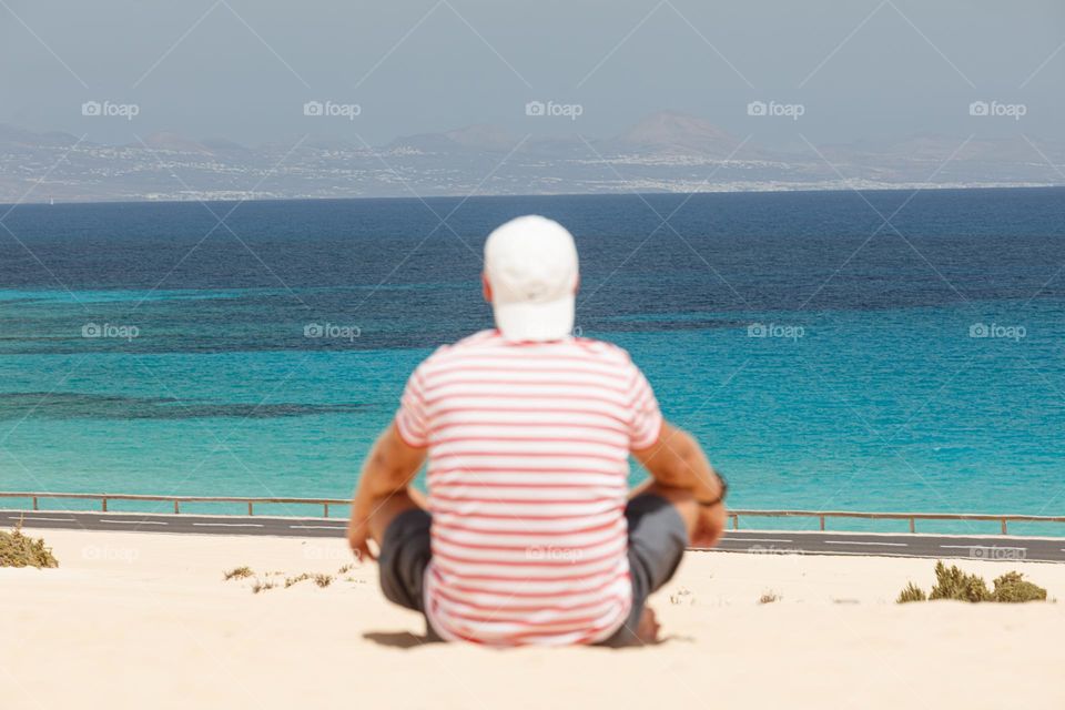 man chilling by the ocean, sea