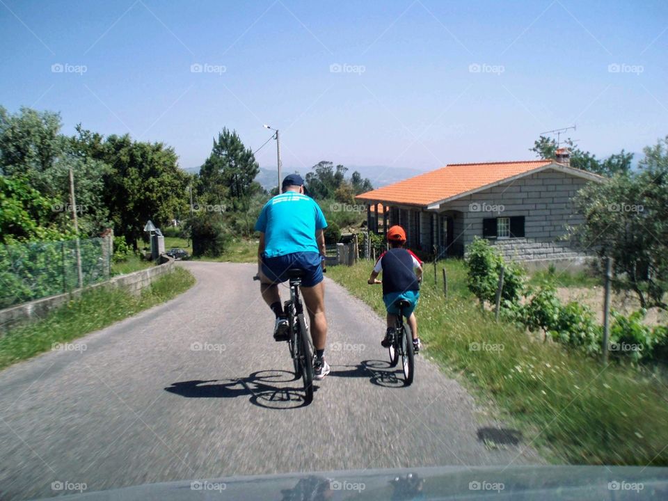 Father and son riding their bikes and keeping in shape
