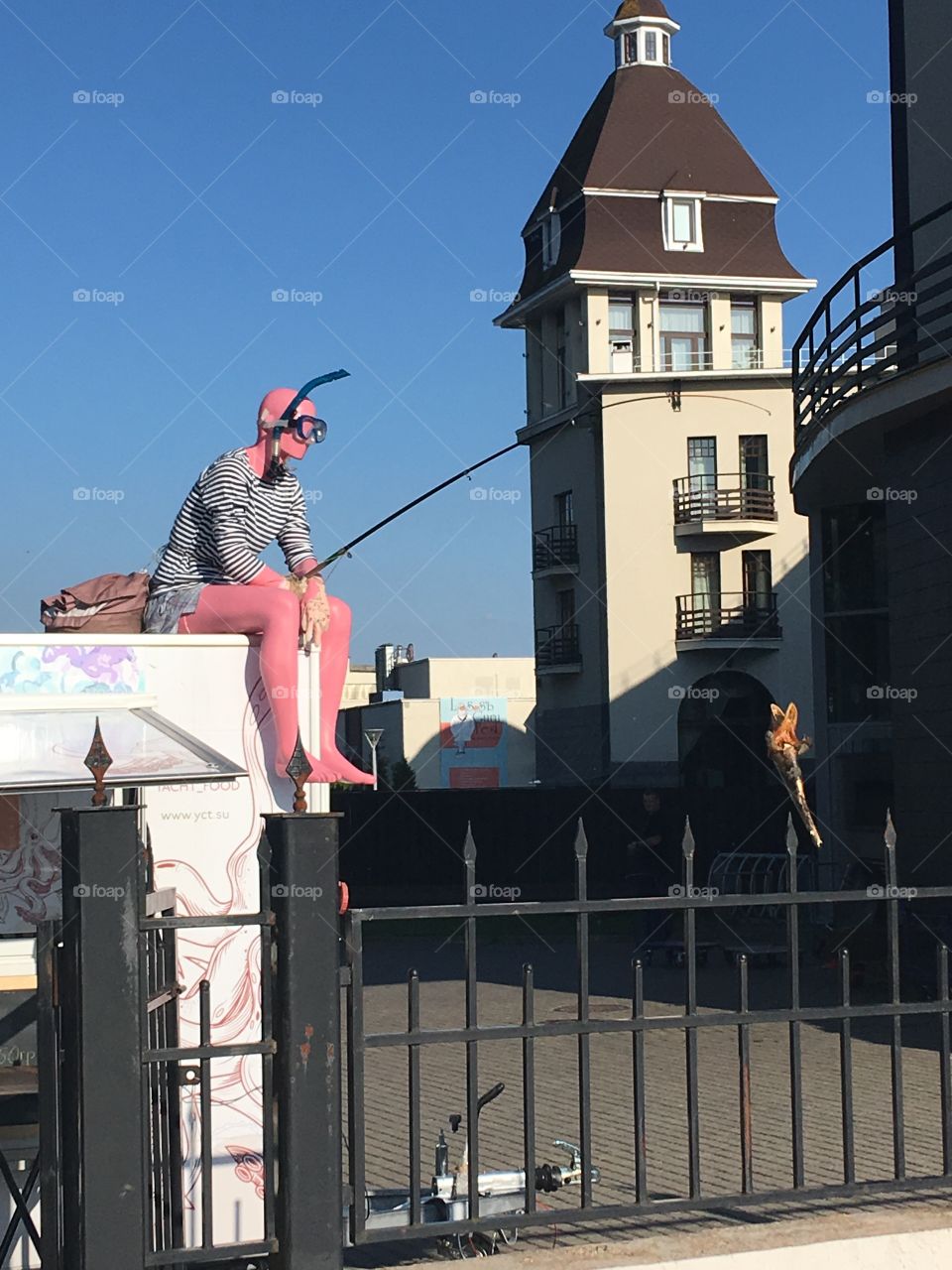 unexpected character with fishing rod in his hands