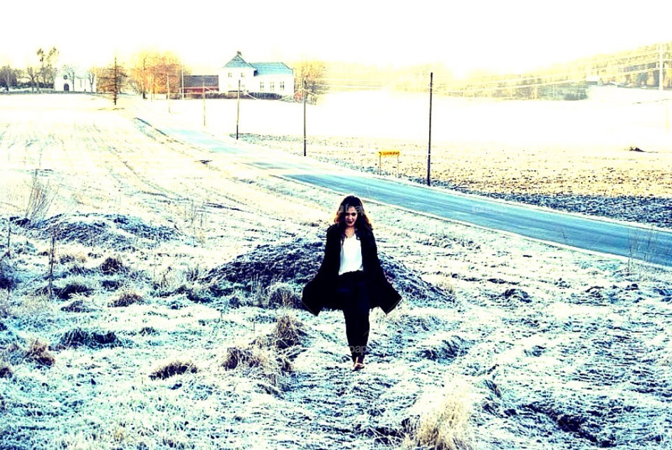 A young girl walking. A young girl walking at the countryside a cold winter day