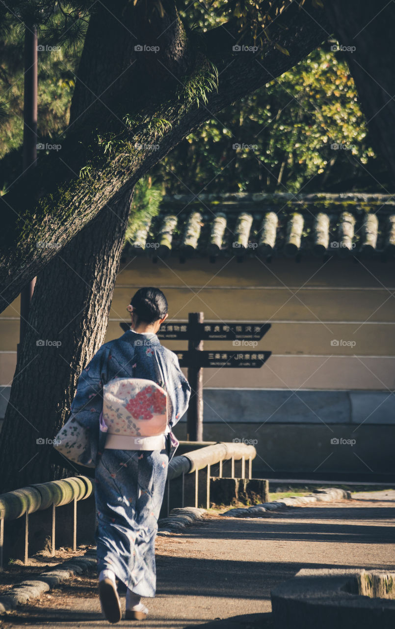 A japanese woman wearing a traditional japanese outfit.