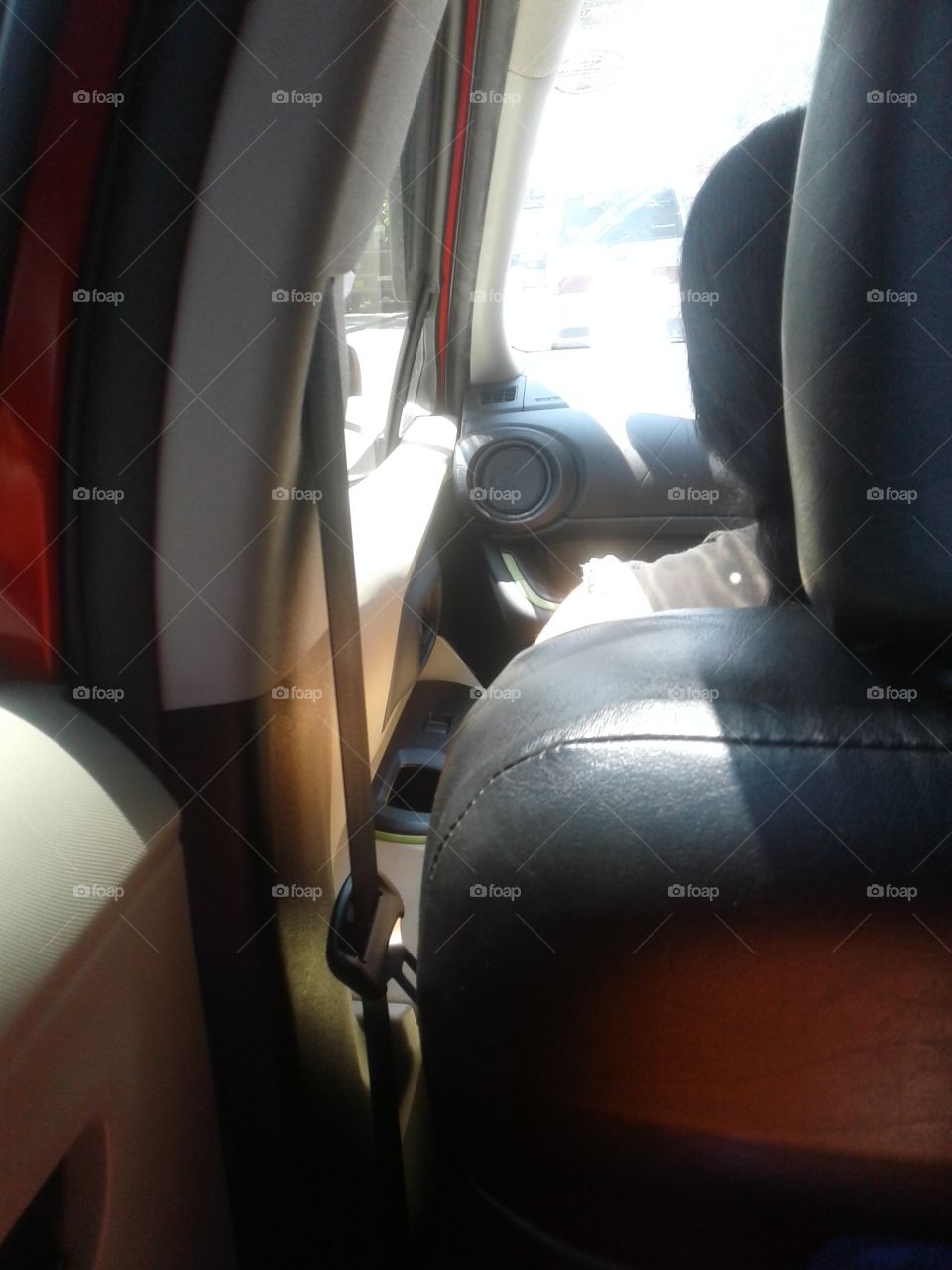 inside of a car.photo of a coner.red coloured luxurious car