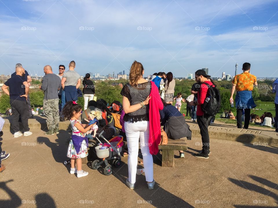 People watching the city skyline of London at Primrose Hills in London.