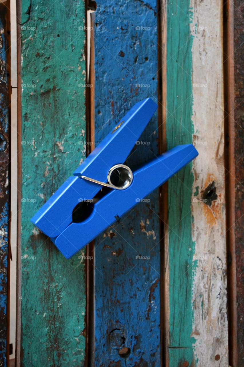 Blue wooden clip on weathered boat boards