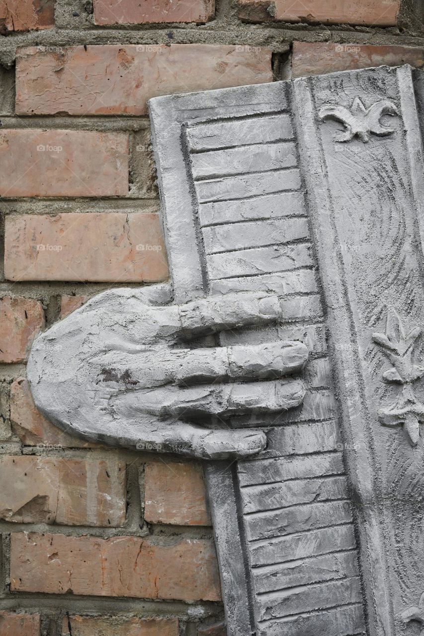 accordion bas-relief on brick wall   street art