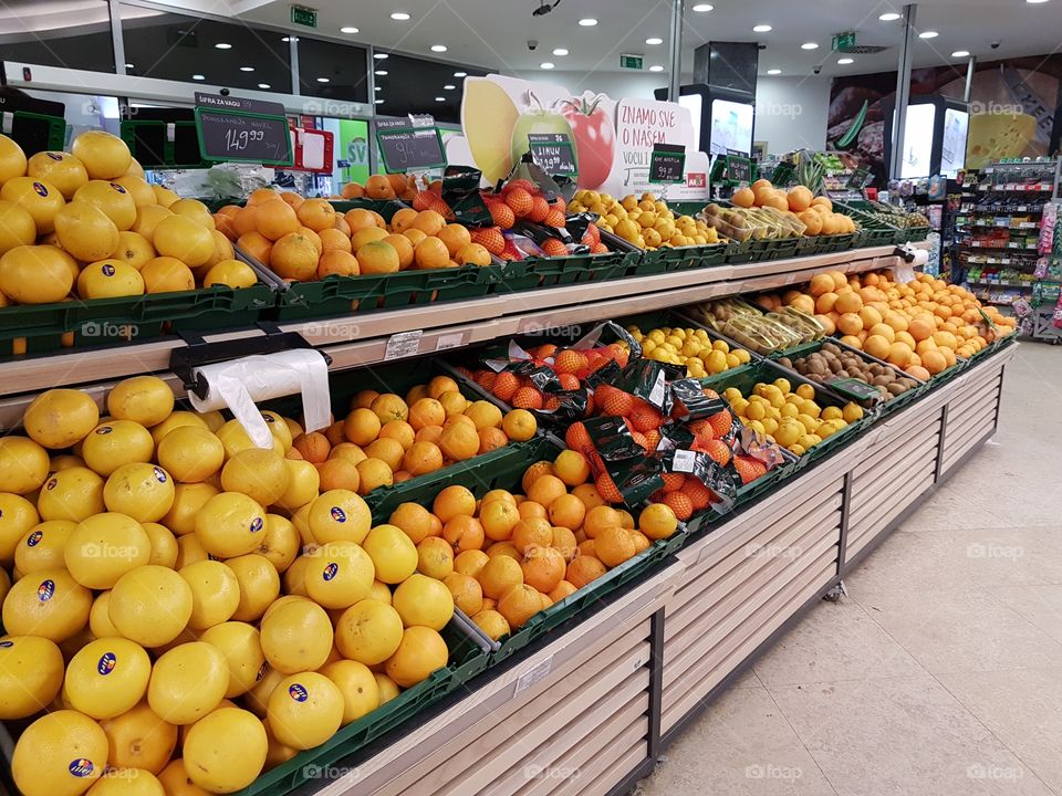 fruit in the supermarket, lemon, orange, ananas