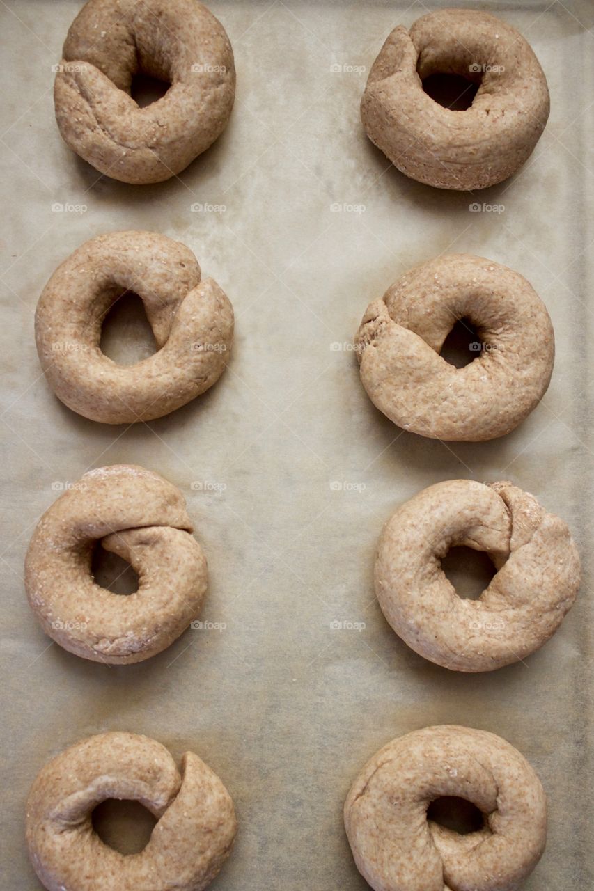 Overhead view of sourdough spelt and whole wheat dough for bagels, on parchment papery