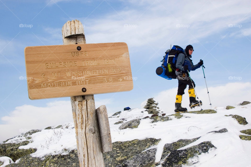 Backpacker At a trail junction on the high summits of the White