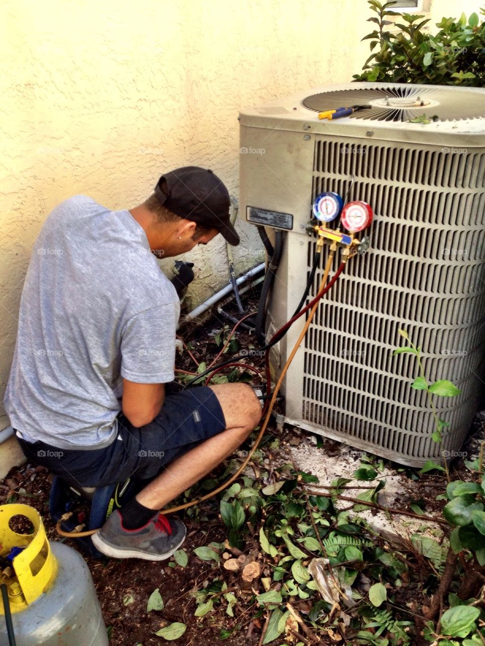 Man repairing air conditioning in a house
