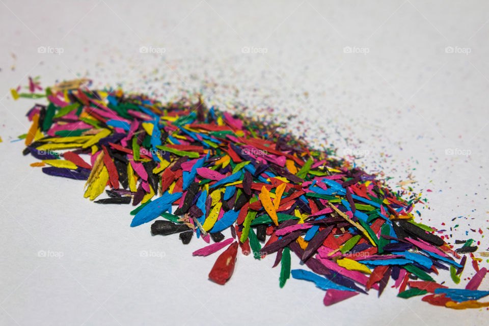 Colorful sprinkles on top of a white background.