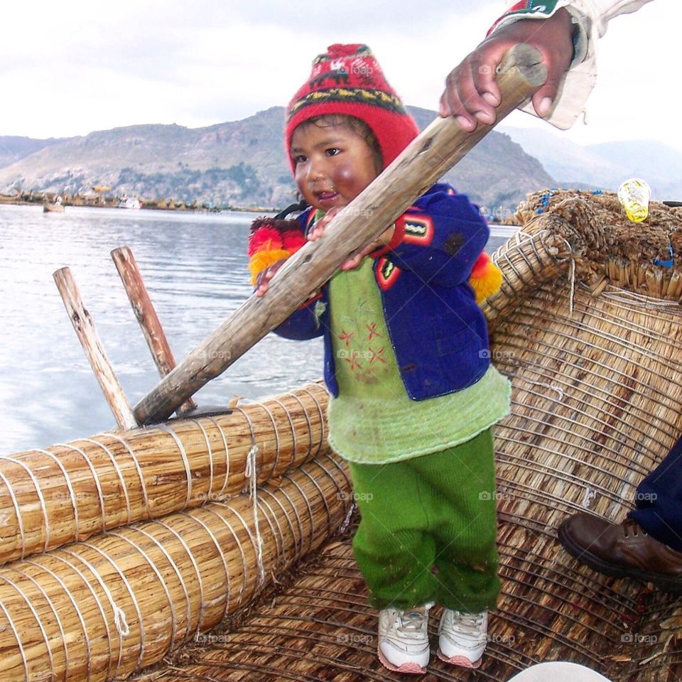 Since the Uros Island of Lake Titicaca is higher in altitude and closer to the sun, one of people's health problem is skin cancer.  Even the kids have burned skin on their faces.  The sun's reflection on the water is not helping this condition. It looked painful but she's still cute :-) 