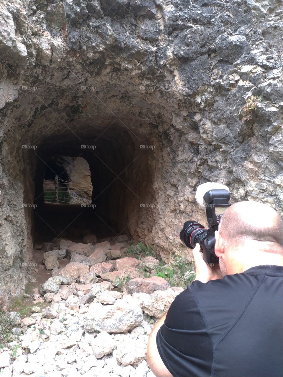 Fotógrafo  trabajando delante de una cueva