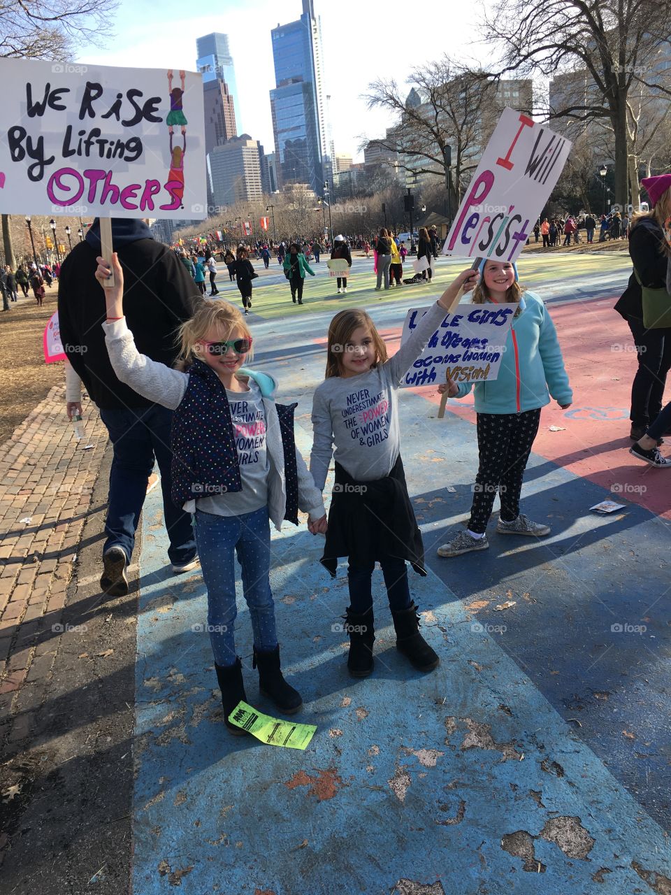 Little girls holding colorful signs at the Philadelphia Women's March 2018
