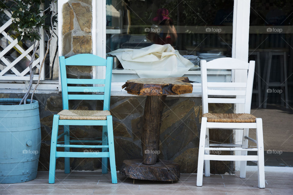 blue and white chairs. blue and white chair in front of the restaurant