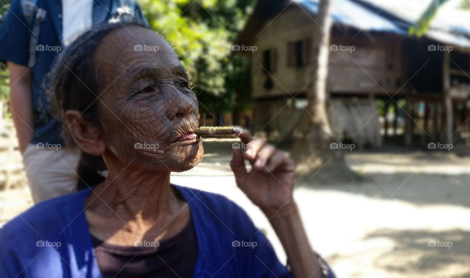 Enjoinable moment on face tatoo of villager in Myanmar