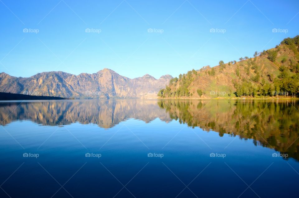 Beautiful nature background Segara Anak Lake in early morning. Mount Rinjani is an active volcano in Lombok, indonesia. Soft focus due to long exposure.
