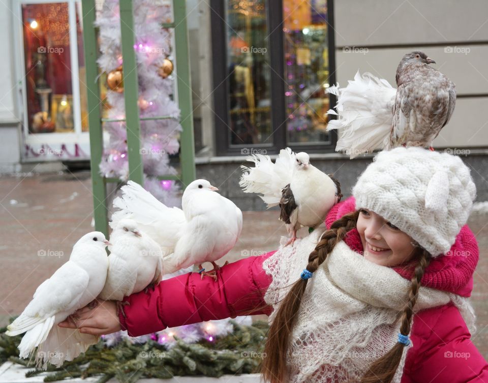 Pigeon birds perching on teenage girl