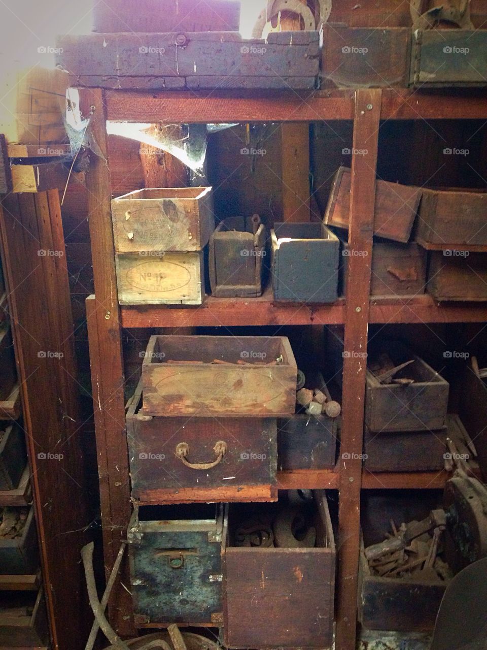 Disorganised messy wooden selves inside a garden shed