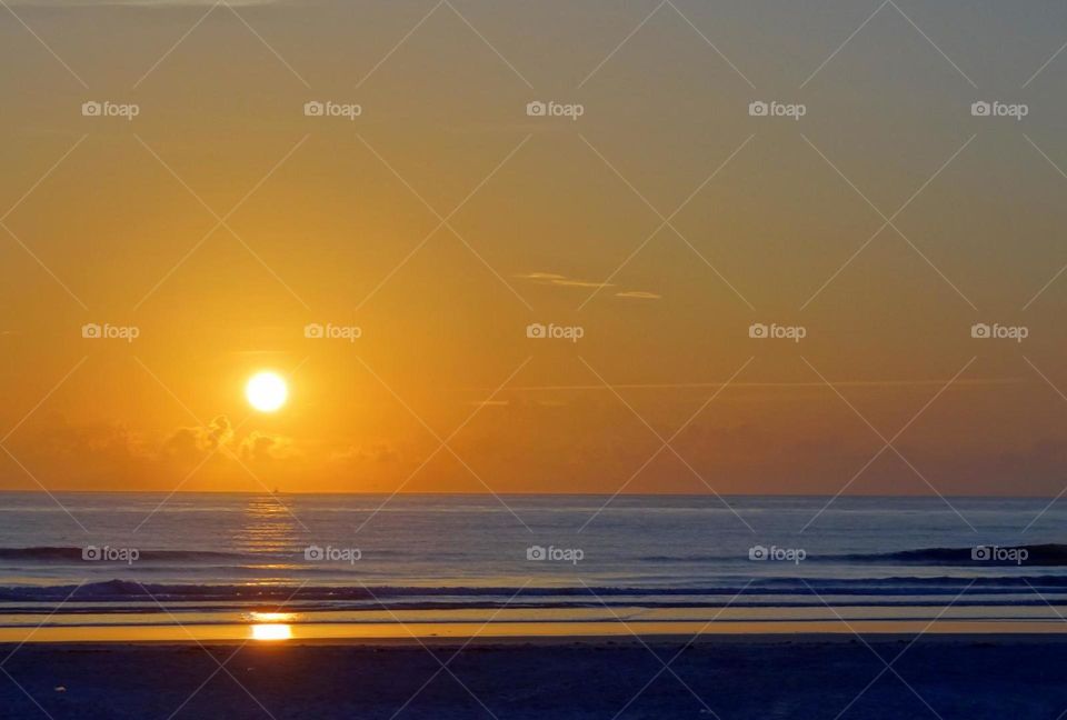 Atlantic Ocean Sunrise. Yellow sun and skies rise over The Atlantic Ocean in Florida